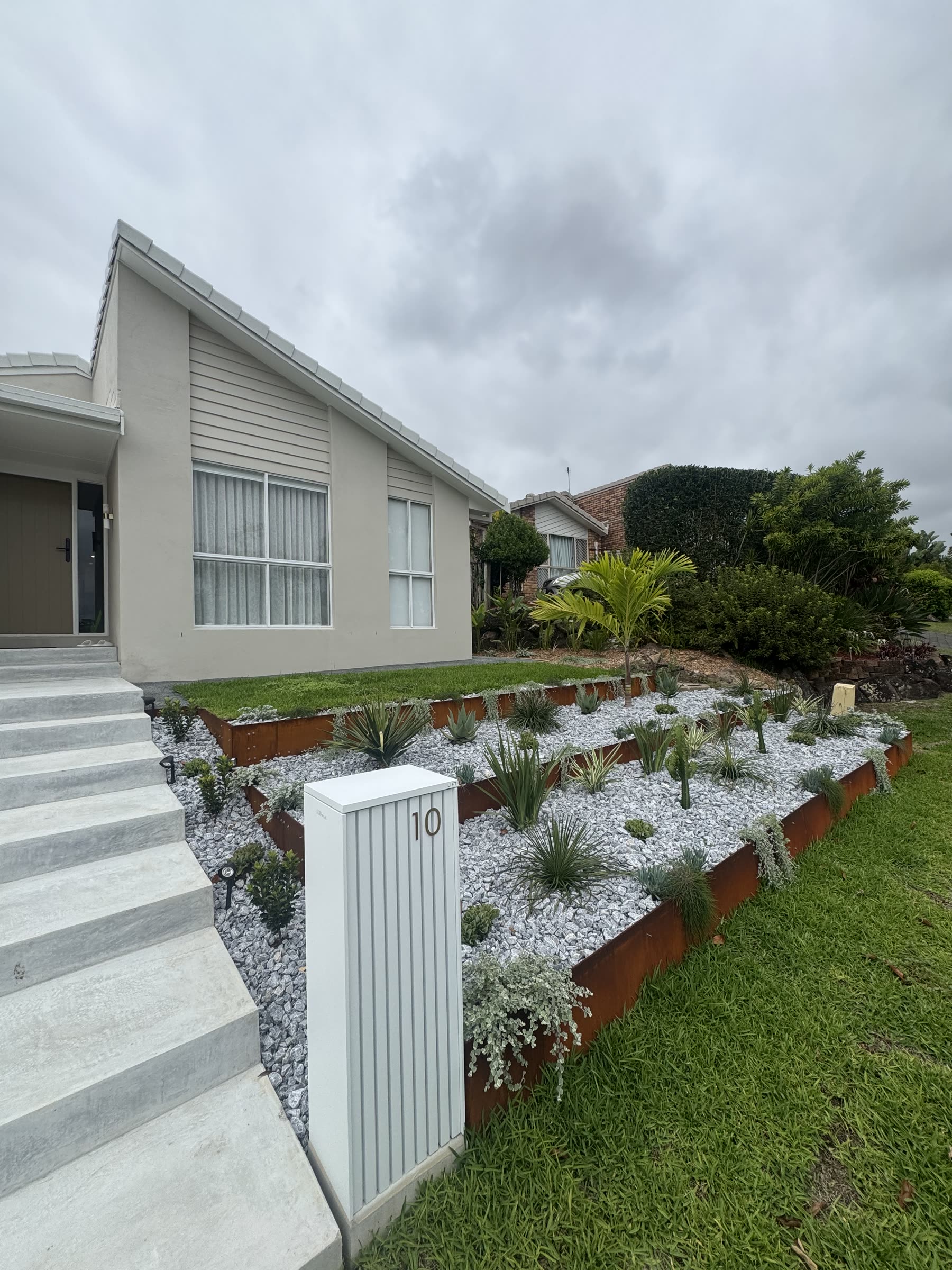 Tiered front garden with corten and pebbles