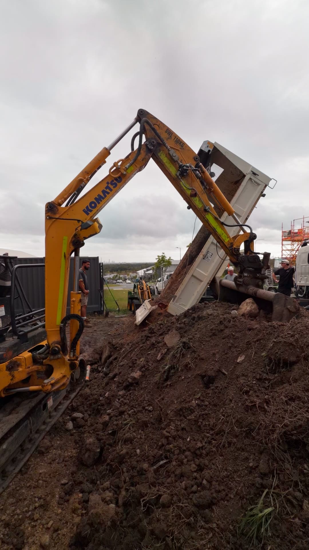 Excavator loading spoil for removal