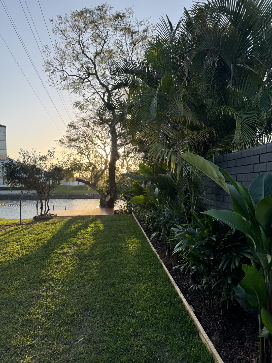 Allambi Ave canal-front garden at dusk